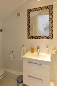 a bathroom with a sink and a mirror at Sun&Sport Apartament AURUM prywatna sauna w cenie in Szczyrk