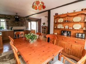 a kitchen and dining room with a wooden table at Swallows Nest at Magnolia Lake in Exeter