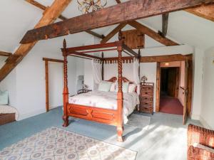 a bedroom with a canopy bed in a attic at Swallows Nest at Magnolia Lake in Exeter