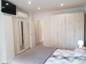 1 dormitorio con 1 cama y TV en la pared en Apartamentos Aranda - Ribera, en Aranda de Duero
