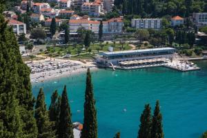 a large body of water with a beach and a building at Apartment Vista 2 in Dubrovnik