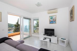 a living room with a couch and a flat screen tv at Apartment Vista 2 in Dubrovnik