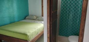 a bedroom with a bed and a toilet in a room at Casa Mafer Lodge in Montañita