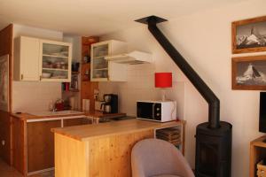 a kitchen with a stove in the corner of a room at Comfortable Apartment With Terrace In Chamonix in Chamonix