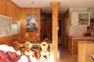 a kitchen and dining room with a table and chairs at Comfortable Apartment With Terrace In Chamonix in Chamonix-Mont-Blanc