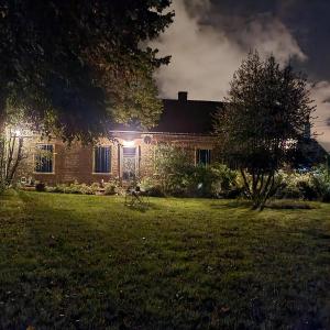 a house at night with a tree in the yard at Gite du Panty in Saint-Tricat