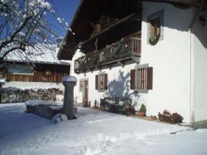 a house with snow on the ground in front of it at Appartement St Nicolas in Saint-Gervais-les-Bains
