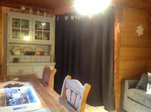 a dining room with a table and chairs and a couch at Appartement St Nicolas in Saint-Gervais-les-Bains