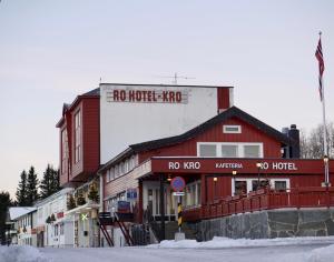 a red and white building with a sign on the side of it at Ro Hotel in Geilo