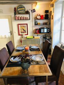 a dining room table with chairs around it at A l'orée de la forêt in Recloses