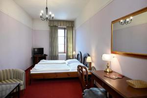 Postel nebo postele na pokoji v ubytování Hotel Bouček