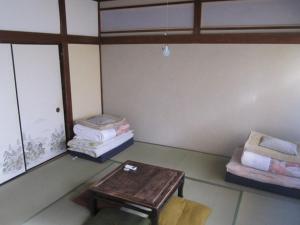 Postel nebo postele na pokoji v ubytování Taito Ryokan