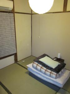 Postel nebo postele na pokoji v ubytování Taito Ryokan