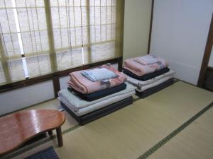 Postel nebo postele na pokoji v ubytování Taito Ryokan