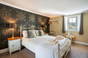 a bedroom with a bed with towels on it at The Bellachroy Hotel in Dervaig