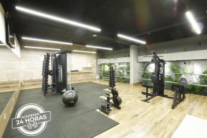 a fitness room with a gym with tread machines at San Marco Hotel Brasília in Brasilia