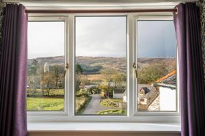a window with a view of a road at The Bellachroy Hotel in Dervaig