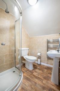 a bathroom with a toilet and a sink and a shower at The Bellachroy Hotel in Dervaig