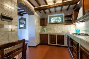 a kitchen with a sink and a counter top at Villa Serena & Dépendances in Cortona