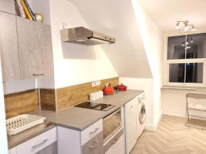 a kitchen with a sink and a stove top oven at Grace Apartments - Living Spring 1 in Ashford