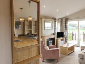a living room with a couch and a chair at Sea Holly Lodge in Saltburn-by-the-Sea