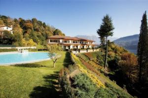 a house on a hill with a swimming pool at TREMEZZO RESIDENCE 2 in Tremezzo
