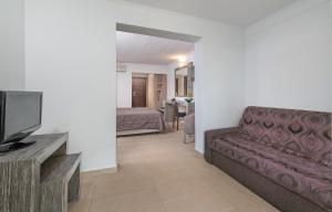 a living room with a couch and a bedroom at Lagomandra Hotel and Spa in Lagomandra