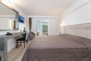 a hotel room with a large bed and a desk at Lagomandra Hotel and Spa in Lagomandra