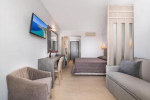 a living room with a couch and a bed at Lagomandra Hotel and Spa in Lagomandra