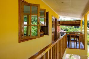 
a view through a window of a kitchen with a balcony at Dream Holiday Self Catering in La Digue
