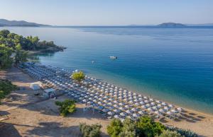 an aerial view of a beach with umbrellas and the water at Lagomandra Hotel and Spa in Lagomandra