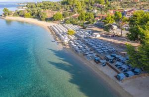 an aerial view of a beach with umbrellas and the ocean at Lagomandra Hotel and Spa in Lagomandra