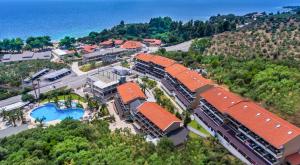 an aerial view of a resort with a pool and the ocean at Lagomandra Hotel and Spa in Lagomandra