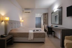 a hotel room with a bed and a desk and a desk at Lagomandra Hotel and Spa in Lagomandra