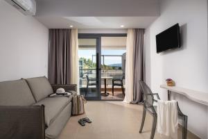 a living room with a couch and a table with chairs at Lagomandra Hotel and Spa in Lagomandra