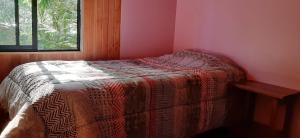 Llit o llits en una habitació de Cabanas El Cipres