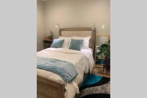 a bedroom with a large bed with blue pillows at Bougainvillea DC 2 bedrooms 2 bathrooms plus den with twin sofa bed and queen sofa bed in living room in Washington
