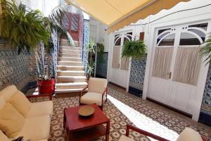 a lobby with a staircase and a door with plants at Patio Central in Santa Cruz de la Palma