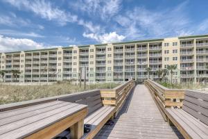 a boardwalk leading to a large apartment building at Waters Edge II in Fort Walton Beach