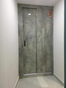 a shower with a glass door in a room at Aloche Apartments in Murree +52 photos