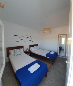 a bedroom with two beds and a mirror at CA NA CATALINA DEN ANDREU in Sant Francesc Xavier