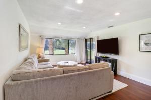 a living room with a couch and a tv at Saddlebrook Golf Course view Condo with Kitchen in Wesley Chapel