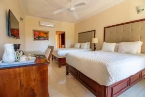 A bed or beds in a room at Travellers Beach Resort