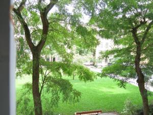 a view of a park with a bench and trees at ApartmentInCopenhagen Apartment 200 in Copenhagen