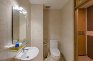 a bathroom with a toilet and a sink and a mirror at Nipola Hotel - Chợ Đêm Dương Đông Phú Quốc in Phú Quốc +18 photos