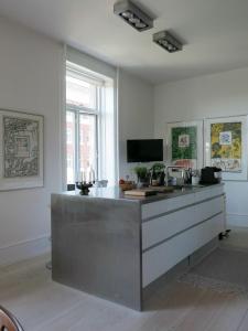 a kitchen with a counter top and a tv at ApartmentInCopenhagen Apartment 1280 in Copenhagen