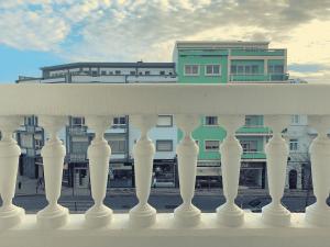 a white fence with a building in the background at Guesthouse Tricana de Aveiro in Aveiro