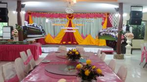 a table set up for a party with a stage at Khao Luang Resort in Lan Saka
