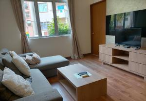 a living room with a couch and a flat screen tv at Seri Bayu Resort Hotel in Kampong Bagan Lalang +23 photos