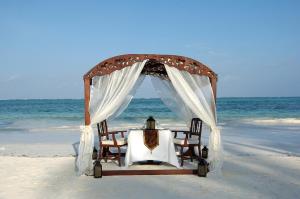 a table and chairs on the beach at The Palms Zanzibar in Bwejuu